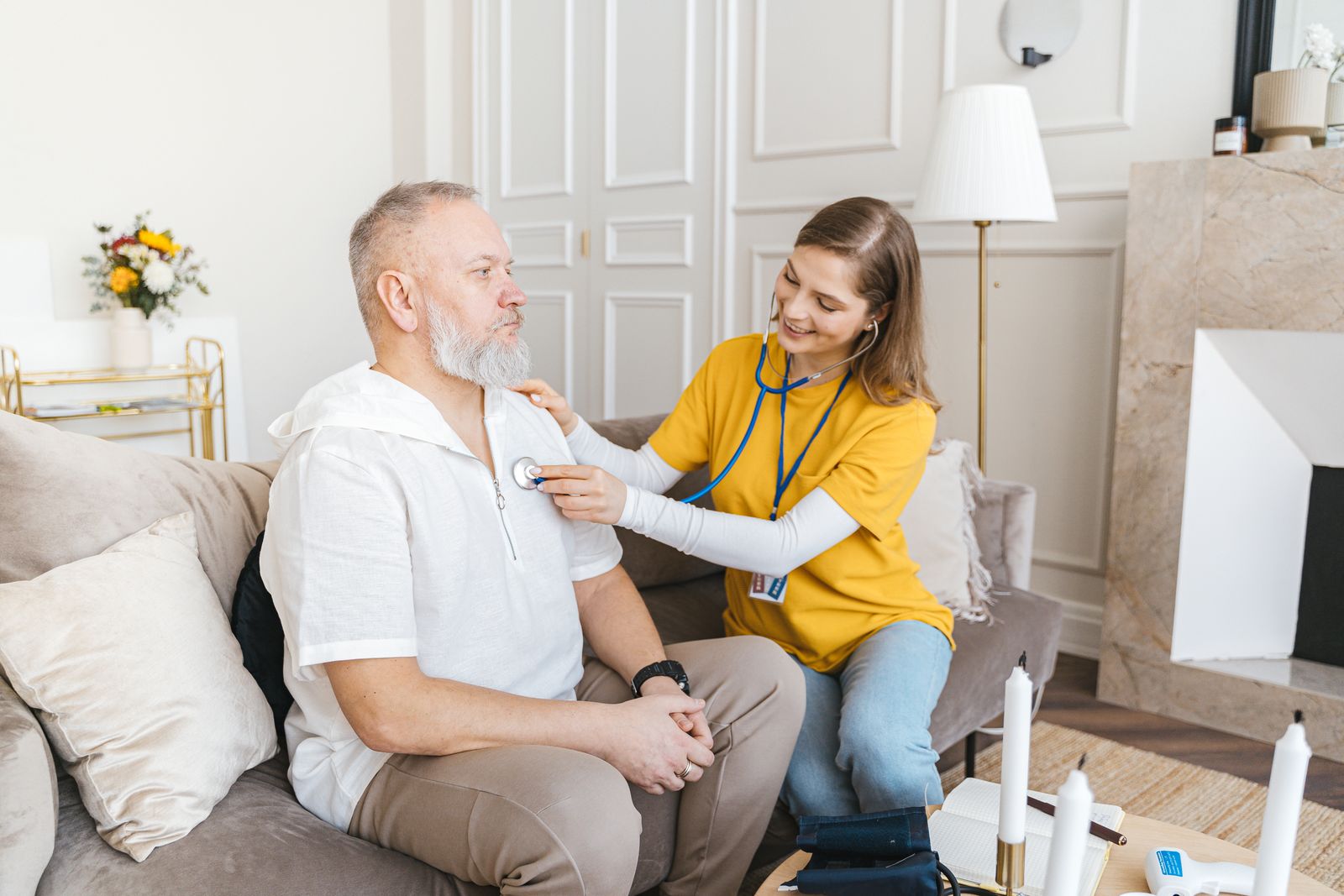 Caregiver checking on a senior man at home